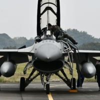Taiwanese Air Force personnel check an armed F-16V fighter at an air base in Chiayi, southern Taiwan, on Jan. 5. | AFP-JIJI