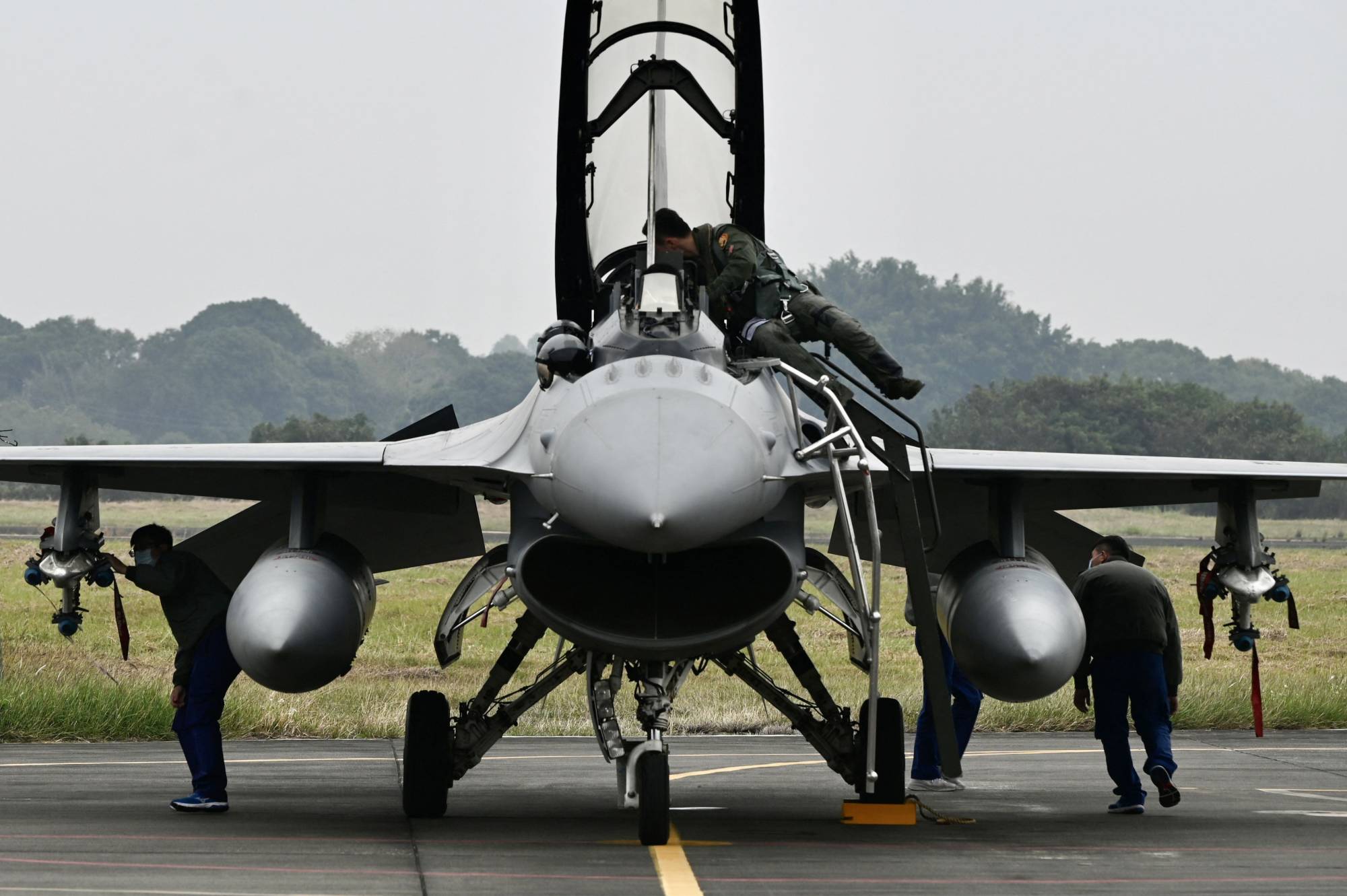 Taiwanese Air Force personnel check an armed F-16V fighter at an air base in Chiayi, southern Taiwan, on Jan. 5. | AFP-JIJI