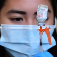 The Moderna COVID-19 vaccine is prepared for administration at a site in Los Angeles on Jan. 7. | AFP-JIJI