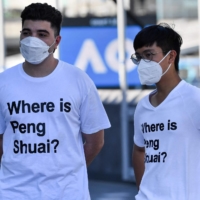 Spectators wear shirts bearing the message \"Where is Peng Shuai,\" outside of Melbourne Park during the Australian Open in Melbourne on Jan. 25. | AFP-JIJI