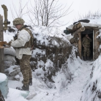 Ukrainian troops patrol on the front line in Opytna, eastern Ukraine, on Monday. Russia has been moving troops and equipment into Belarus ahead of joint exercises next month.  | TYLER HICKS/THE NEW YORK TIMES
