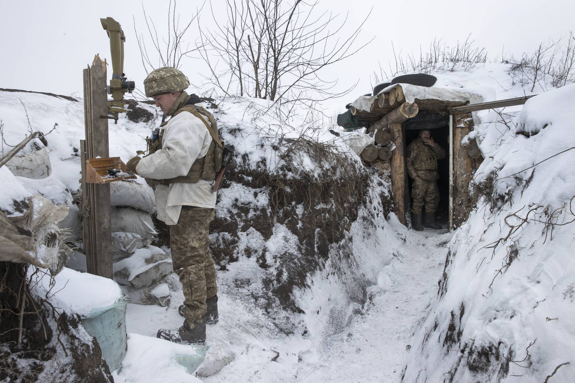 Ukrainian troops patrol on the front line in Opytna, eastern Ukraine, on Monday. Russia has been moving troops and equipment into Belarus ahead of joint exercises next month. | Tyler Hicks/The New York Times