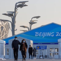 People walk near Beijing\'s National Stadium on Jan. 6. The Games open on Friday. 

, a venue of the Beijing 2022 Winter Olympics in Beijing, China, January 6, 2022.   REUTERS/Thomas Peter | REUTERS 