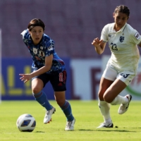 Hikaru Naomoto runs with the ball during Japan\'s Asian Cup quarterfinal against Thailand in Navi Mumbai, India, on Sunday. | REUTERS