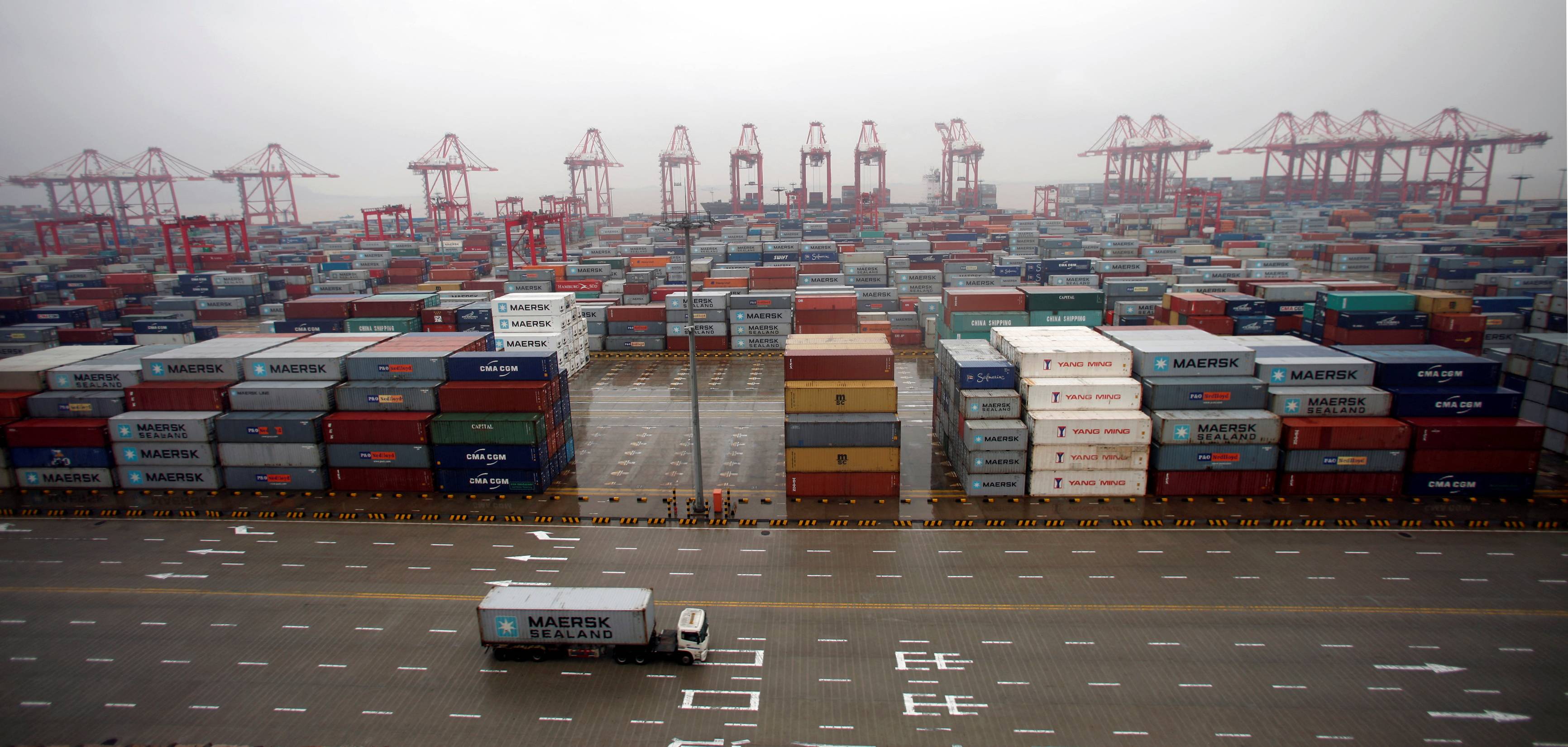 A container truck drives through Yangshan Deep Water Port near Shanghai in 2012.  | REUTERS