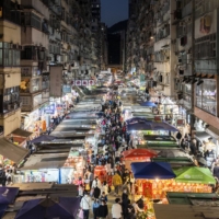 Crowds of shoppers walk through a street market in Hong Kong on Sunday.  | BLOOMBERG