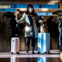 A passenger walks the arrival hall at Tokyo\'s Haneda Airport. | AFP-JIJI