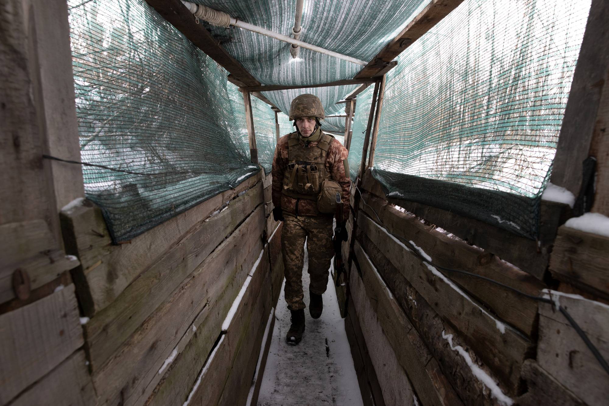 A Ukrainian soldier walks in a trench in Marinka, Ukraine, Thursday, Jan. 27. | Tyler Hicks / The New York Times