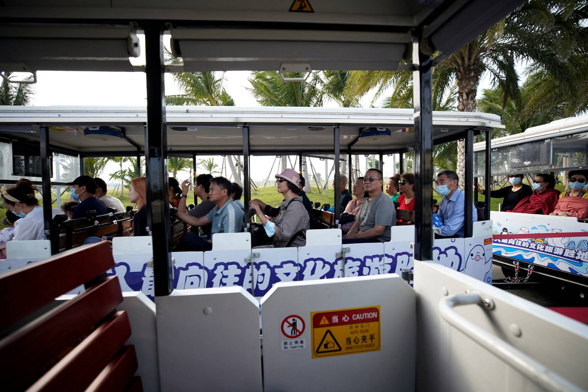 Visitors ride a shuttle bus on the man-made Ocean Flower Island, a resort developed by China Evergrande Group, in Danzhou, Hainan province, China, on Jan. 7. | REUTERS