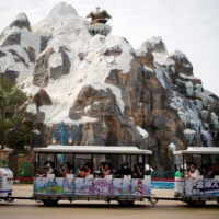 Visitors ride a shuttle bus at a theme park on the man-made Ocean Flower Island, a resort developed by China Evergrande Group, in Danzhou, Hainan province, China, on Jan. 7. | REUTERS