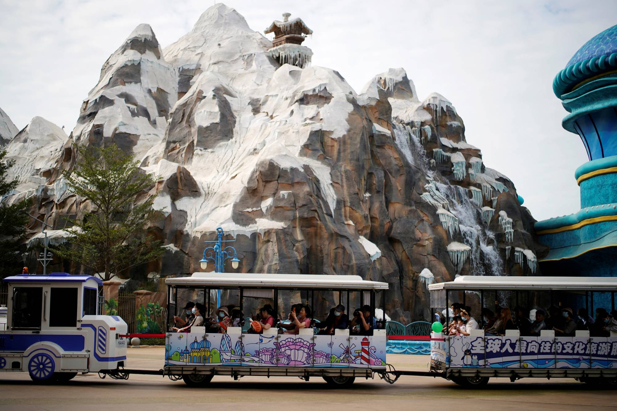 Visitors ride a shuttle bus at a theme park on the man-made Ocean Flower Island, a resort developed by China Evergrande Group, in Danzhou, Hainan province, China, on Jan. 7. | REUTERS