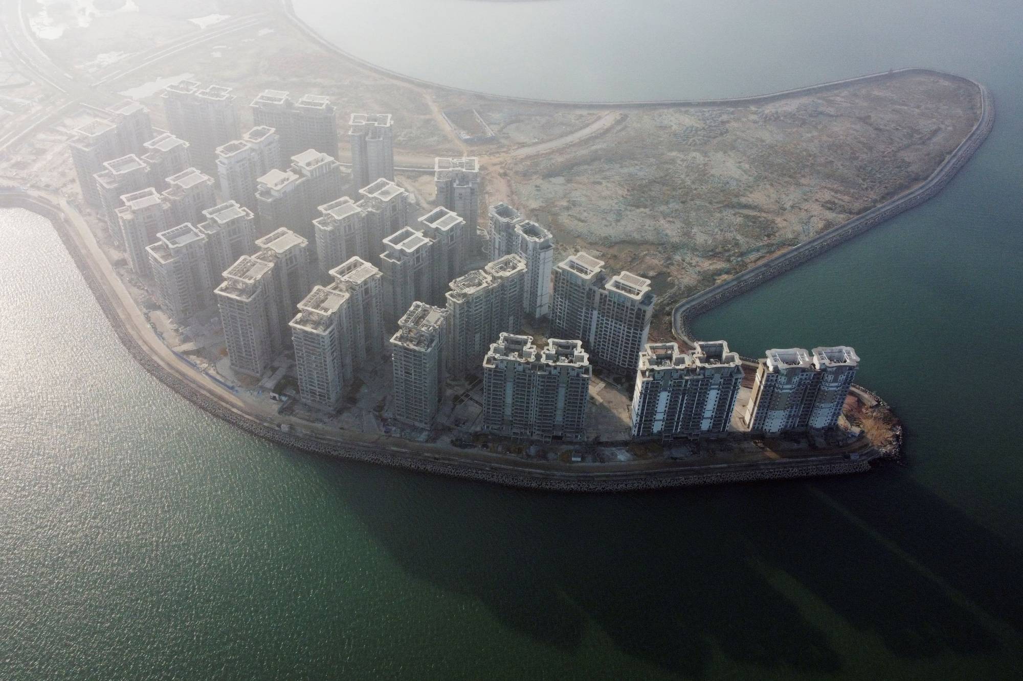 Thirty-nine buildings developed by China Evergrande Group that authorities have issued demolition orders for, on the man-made Ocean Flower Island in Danzhou, Hainan province, China, on Jan. 7 | REUTERS