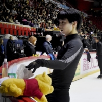 Yuzuru Hanyu of Japan takes out a tissue from a Winnie the Pooh tissue box during men\'s practice at the figure skating ISU Helsinki Grand Prix in Helsinki, Finland, Nov. 2, 2018.   | REUTERS