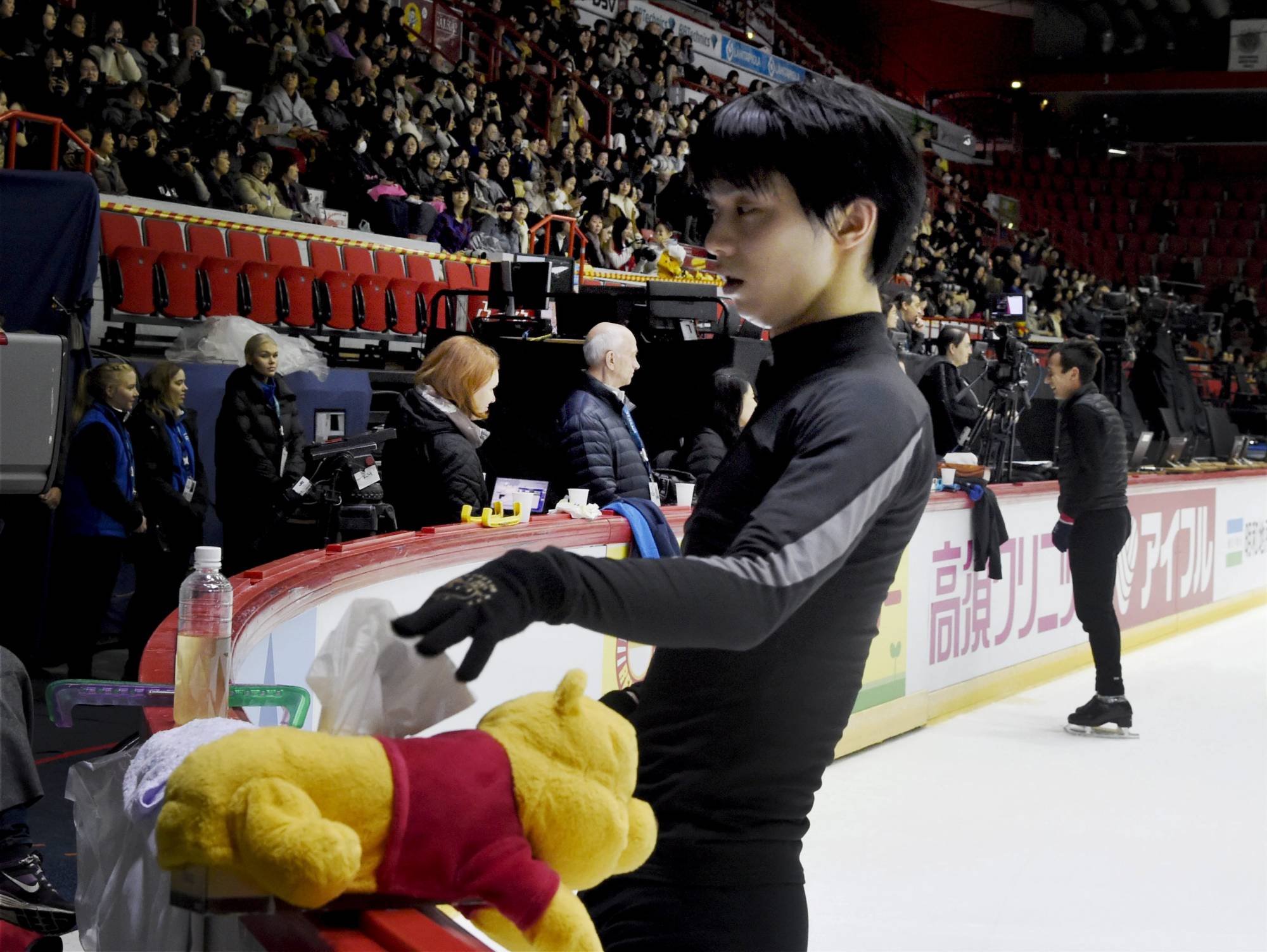 Yuzuru Hanyu of Japan takes out a tissue from a Winnie the Pooh tissue box during men's practice at the figure skating ISU Helsinki Grand Prix in Helsinki, Finland, Nov. 2, 2018. | Reuters
