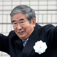 Then-Tokyo Gov. Shintaro Ishihara waves to voters while on the campaign trail in the capital in April 2007. Ishihara has died at the age of 89, his family said Tuesday. | REUTERS