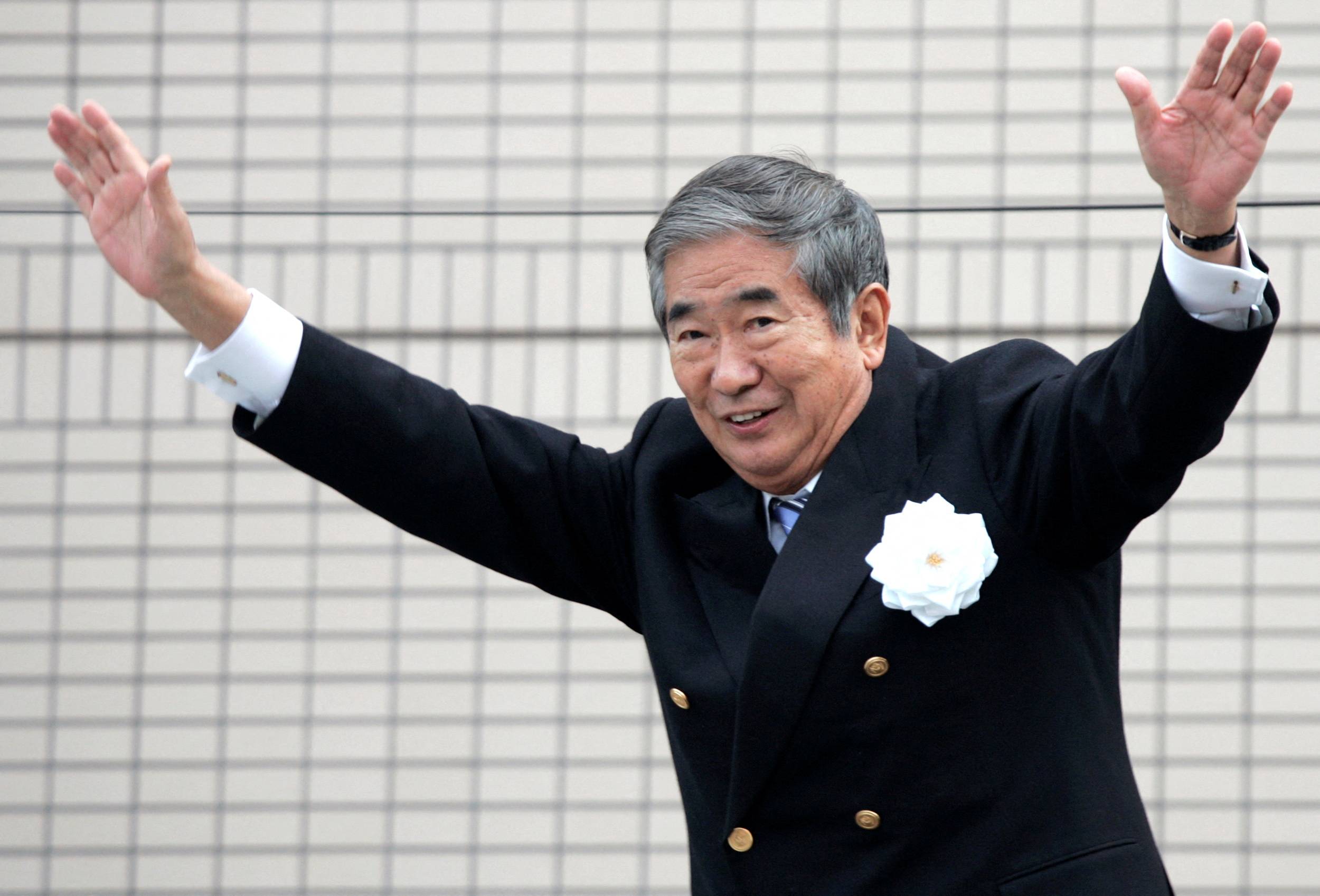 Then-Tokyo Gov. Shintaro Ishihara waves to voters while on the campaign trail in the capital in April 2007. Ishihara has died at the age of 89, his family said Tuesday. | REUTERS
