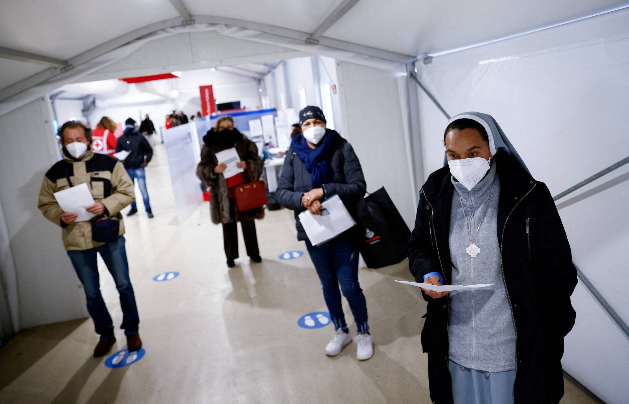 People wait to get a COVID-19 vaccine at a Red Cross vaccination center in Rome on Jan. 10. | REUTERS
