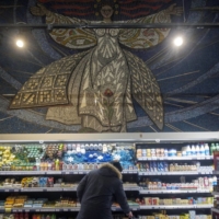 A Soviet-era mosaic above an aisle of a grocery store in Mariupol | BLOOMBERG 
