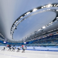 Japanese athletes take part in a training session at the National Speed Skating Oval in Beijing on Tuesday. Tokyo effectively threw its support behind the U.S.-led diplomatic boycott of the Games by holding off on sending government representatives. | AFP-JIJI