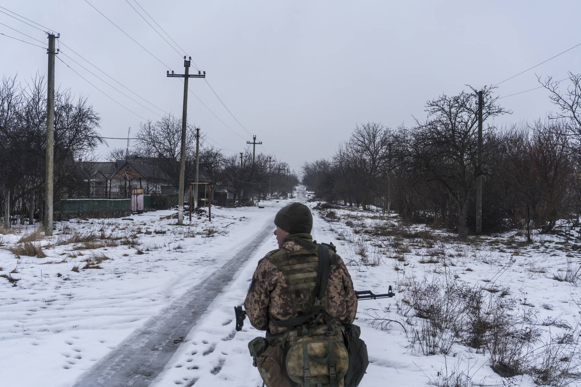 Soldiers with Ukrainian Army’s 53rd Mechanized Brigade walk from a front line position in Novotroitske, Ukraine, on Wednesday. | BRENDAN HOFFMAN / THE NEW YORK TIMES