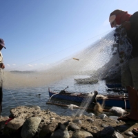 Philippine fishermen sort their nets in the coastal town of Masinloc, Zambales, which is located about 130 nautical miles from the disputed Scarborough Shoal, in April 2015. According to the U.N., the South China Sea produces 12% of the world’s fish catch. |  REUTERS