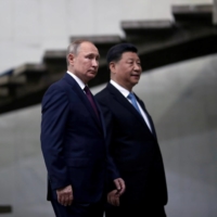 Russia\'s President Vladimir Putin and China\'s Xi Jinping arrive for a BRICS summit in Brasilia in November 2019. | REUTERS