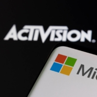 Microsoft logo is seen on a smartphone placed on displayed Activision Blizzard logo in this illustration taken Jan. 18. | REUTERS