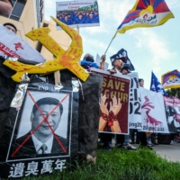 Various human rights groups rally against alleged human rights violations by the Chinese government ahead of the Beijing Winter Olympics outside the Chinese consulate in Los Angeles, California, on Thursday. | REUTERS
