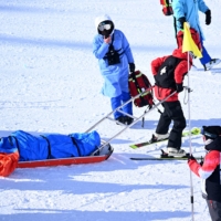 Rina Yoshika is taken off the course after being injured during a training run in  Zhangjiakou, China, on Thursday. | REUTERS