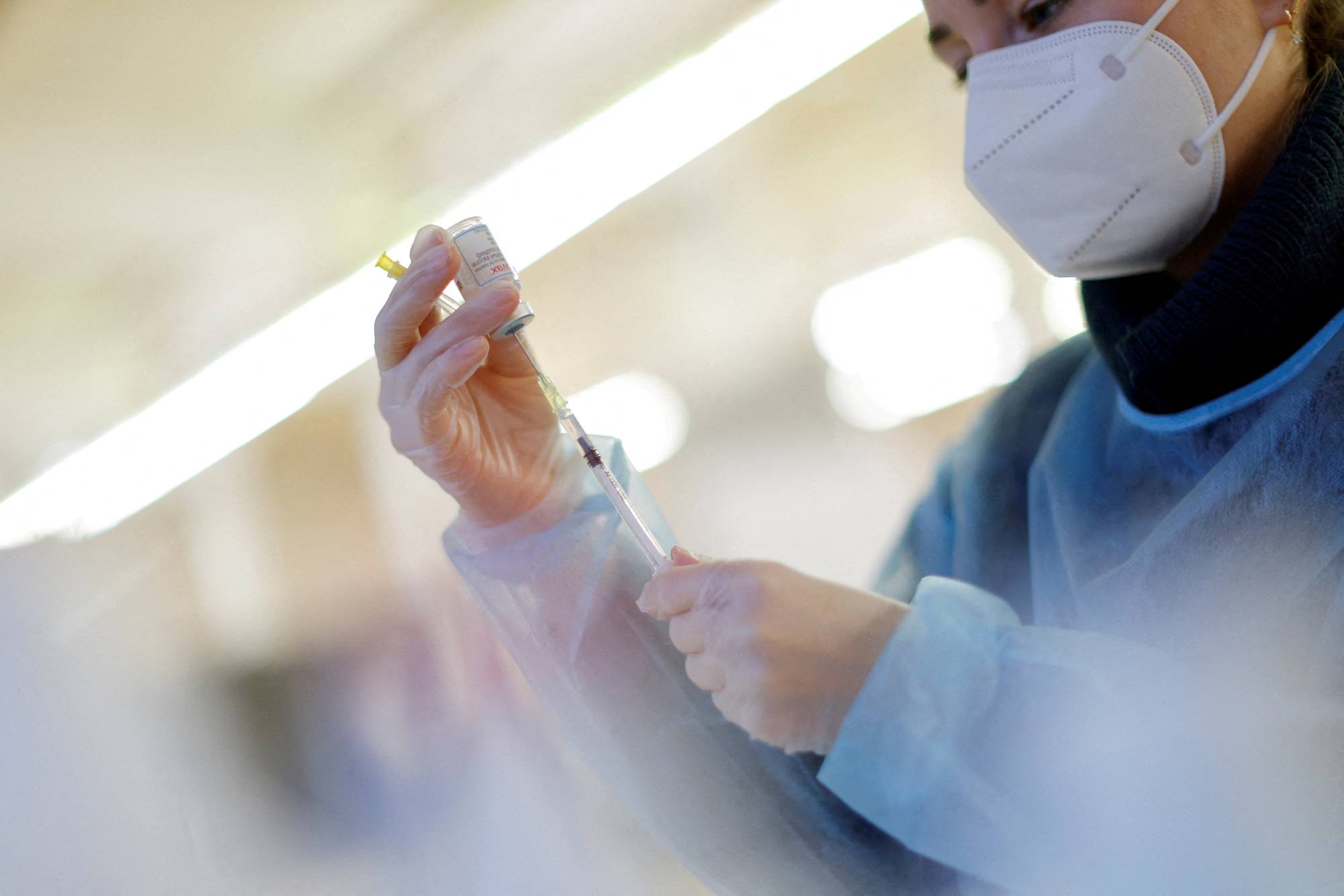 A nurse prepares a booster dose of the Moderna COVID-19 vaccine in Berlin on Jan. 1.  | REUTERS
