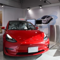 A Tesla Inc. Model 3 electric vehicle is displayed inside the company\'s showroom in the Shibuya district of Tokyo. | BLOOMBERG