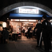 Social practices in Japan that often encourage both camaraderie and peer pressure — after-work drinking parties, for example — have largely taken a back seat amid the pandemic. | SOICHIRO KORIYAMA / BLOOMBERG