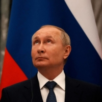 Russian President Vladimir Putin looks up during a joint press conference with French President Emmanuel Macron after their talks in Moscow on Monday. | REUTERS