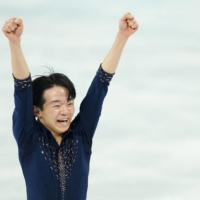Yuma Kagiyama of Japan reacts after his performance in the short program portion of the men\'s single skating event at the 2022 Winter Olympics in Beijing on Tuesday. | REUTERS