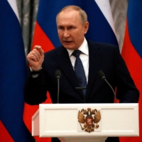 Russian President Vladimir Putin during a news conference in Moscow on Monday  | POOL / VIA REUTERS 