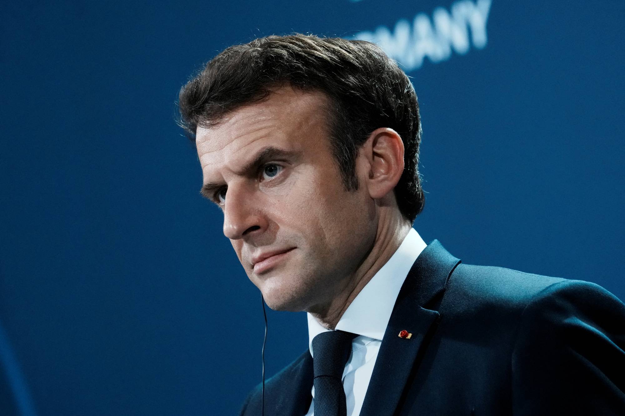 French President Emmanuel Macron looks on during a news conference in Berlin on Tuesday. | Pool / via Reuters 