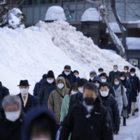 Commuters in Sapporo on Wednesday | KYODO