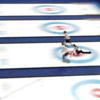 Kim Eun-jung, the captain, releases a stone during a game between South Korea and Sweden at the 2018 Pyeongchang Olympics. | CHANG W. LEE / THE NEW YORK TIMES