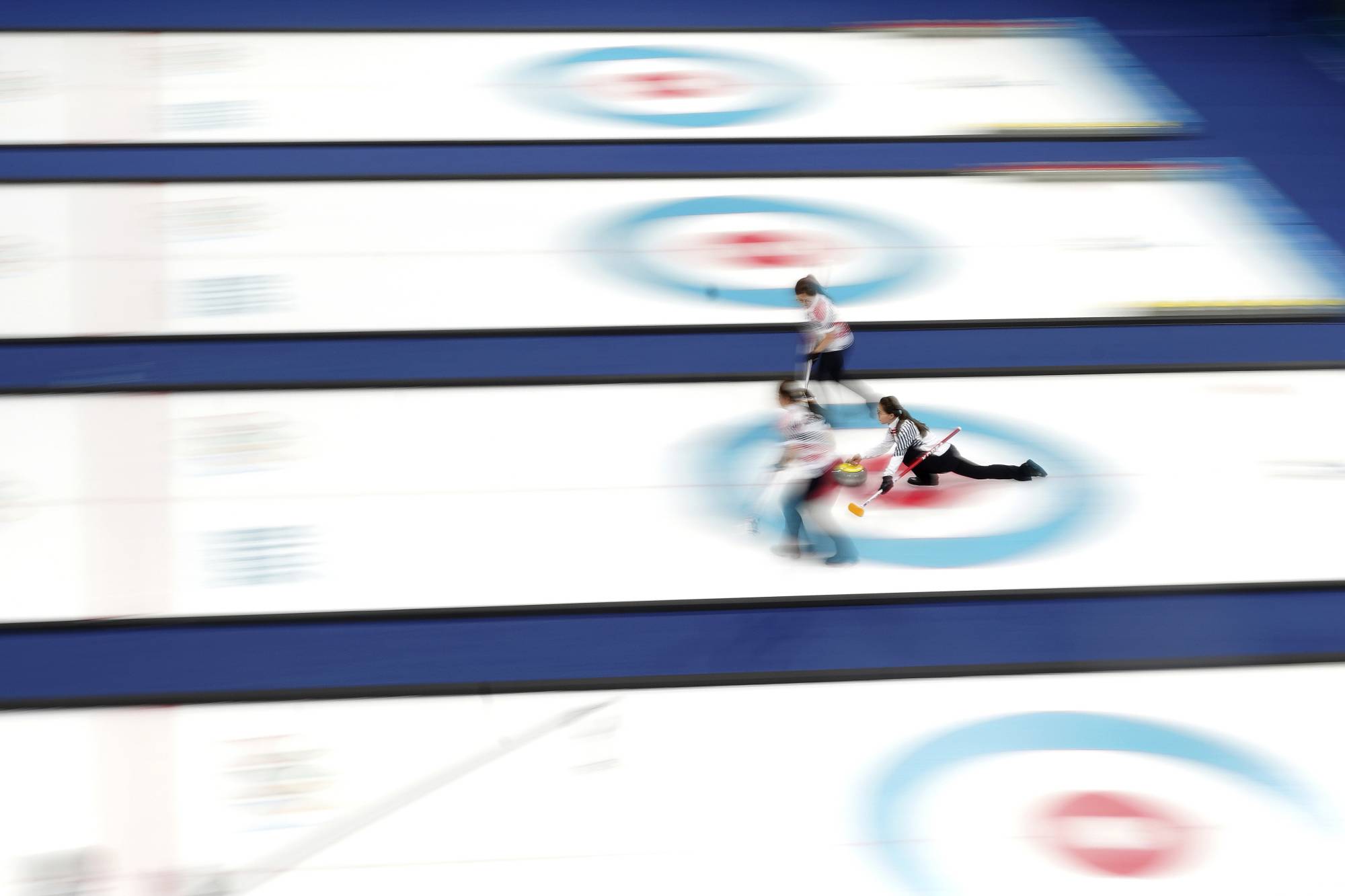 Kim Eun-jung, the captain, releases a stone during a game between South Korea and Sweden at the 2018 Pyeongchang Olympics. | Chang W. Lee / The New York Times