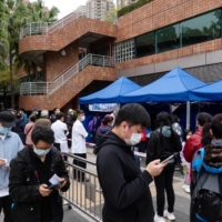 Residents queue at a COVID-19 testing facility in the Shatin area of Hong Kong on Thursday. | BLOOMBERG