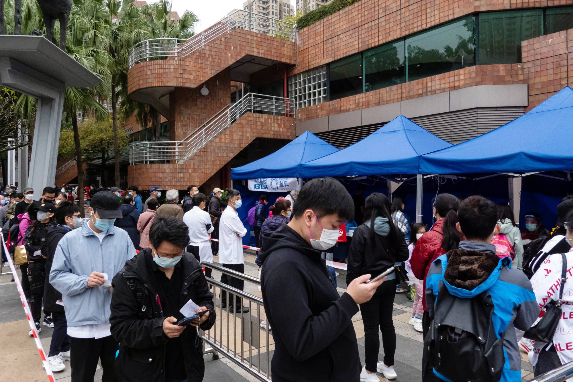 Residents queue at a COVID-19 testing facility in the Shatin area of Hong Kong on Thursday. | Bloomberg