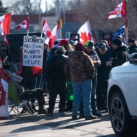 Vehicles and protesters block access to the Ambassador Bridge that connects Detroit and Windsor, Ontario, on Wednesday.  | BLOOMBERG