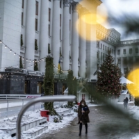 Pedestrians walk past the Presidential Administration Building in Kyiv on Jan. 26.  | BRENDAN HOFFMAN / THE NEW YORK TIMES