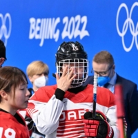 Japan\'s Akane Shiga reacts after her team\'s 7-1 quarterfinal loss to Finland on Saturday.  | AFP-JIJI