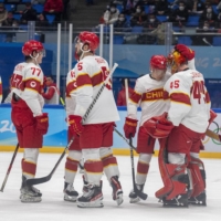 Chinese players greet goalie Jeremy Smith after their 8-0 loss to the United States during a preliminary-round game. | JAMES HILL / NEW YORK TIMES