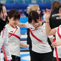 (From left) Satsuki Fujisawa, Yumi Suzuki, Yurika Yoshida and Chinami Yoshida celebrate after Japan\'s win over the Russian Olympic Committee in the Olympic women\'s curling tournament in Beijing on Saturday. | REUTERS