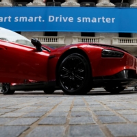 An XPeng Inc. P7 performance electric car is displayed outside the New York Stock Exchange in August 2020. Beijing is shooting its car industry in the foot with cybersecurity legislation that would seek data collected by new cars on their drivers, the roads they travel and the faces they pass.  | REUTERS 