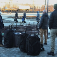 People including members of the OSCE gather at a railway station to board a train to Kyiv while leaving the town of Kramatorsk in Ukraine\'s eastern Donetsk region on Sunday. | REUTERS