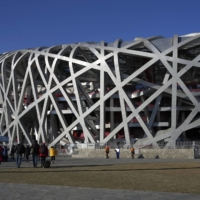 The National Stadium, also known as the Bird’s Nest. Hosting the Winter Olympics is costing China billions of dollars, a scale of expenditure that has made the event less appealing to many cities. | HIROKO MASUIKE / THE NEW YORK TIMES