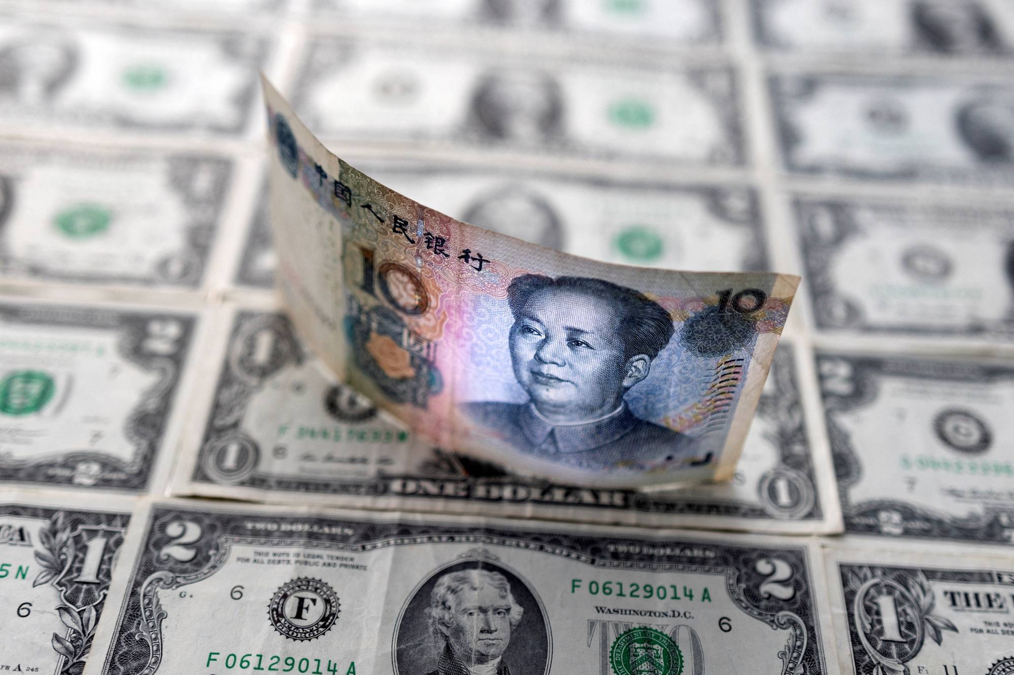 Slowing economic momentum and policy easing in China, amid expectations for as many as seven U.S. rate hikes this year, has cast a pall over the yuan outlook, historically an ill wind for neighbors. | REUTERS